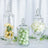 Glass apothecary jars with decorative fillers in various sizes and colors.