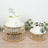 Elegant birthday cakes on decorative stands with floral accents.