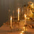 Elegant candle holders with candles, glowing softly in a romantic setting.