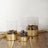 Decorative glass vases with gold honeycomb bases filled with natural elements
