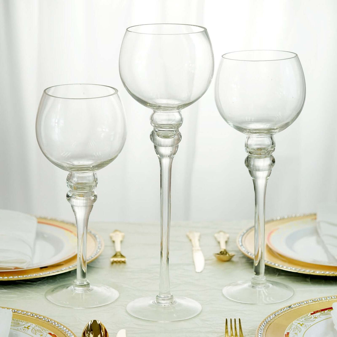 Elegant set of three glass goblets on a dining table.