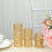 Set of three decorative amber glass vases in varying heights.