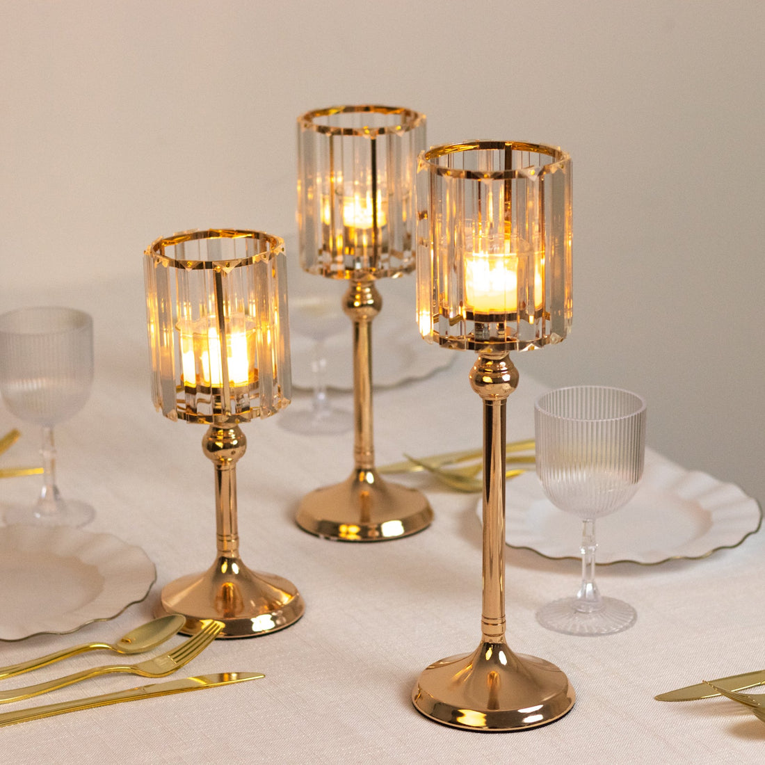 Elegant gold and crystal candle holders on a dining table.
