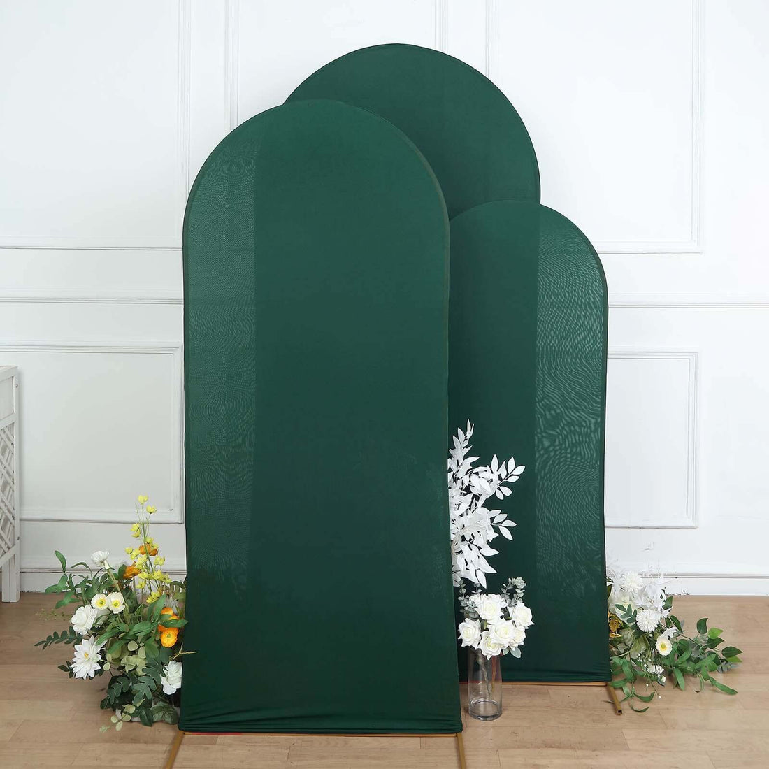 Green fabric room dividers with floral accents on a plain background.