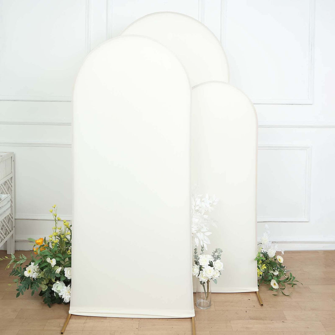 Three elegant curved backdrop panels in cream color with floral accents.