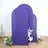 Purple fabric backdrops with floral arrangements for photography.