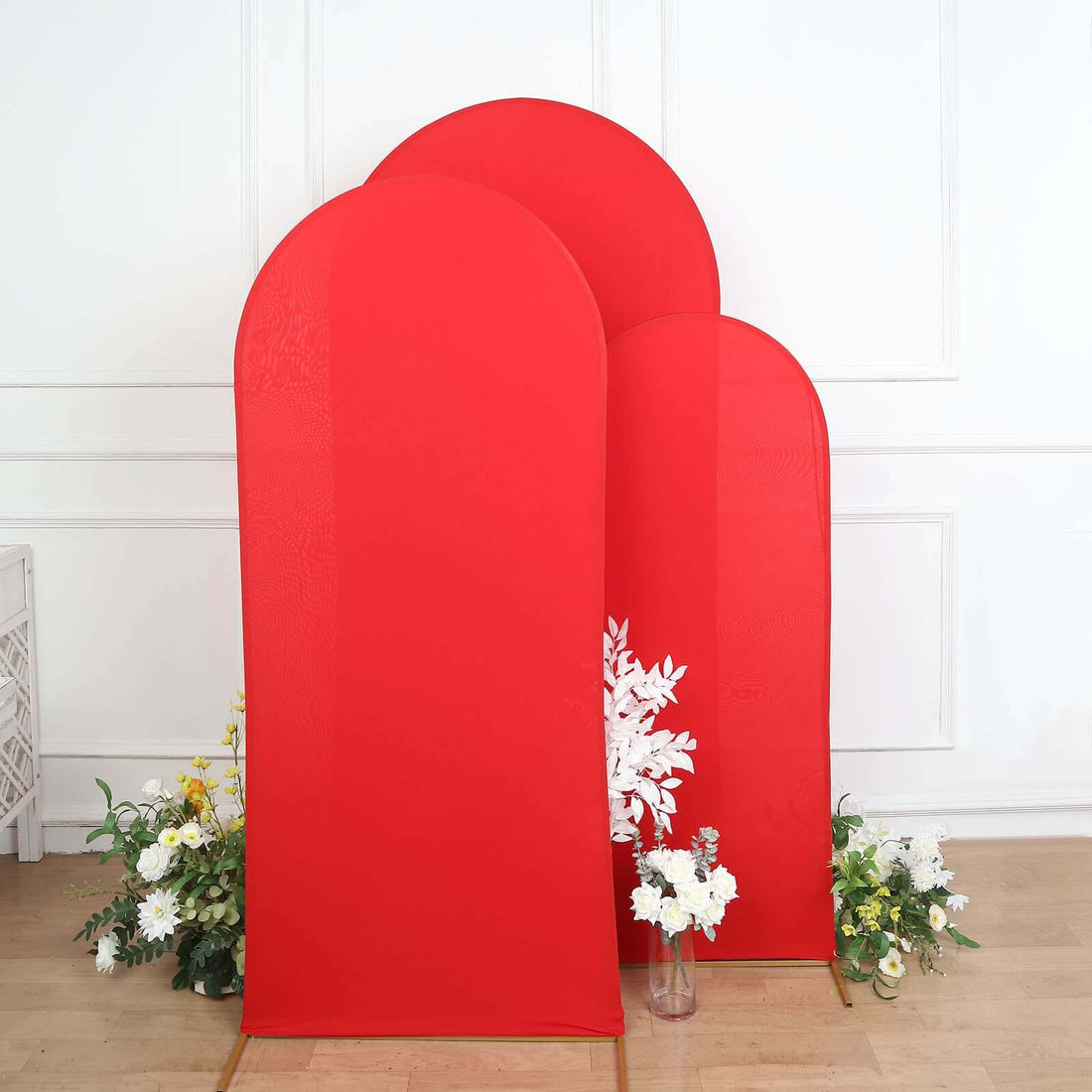 Three tall red backdrop panels with white flowers at the base.
