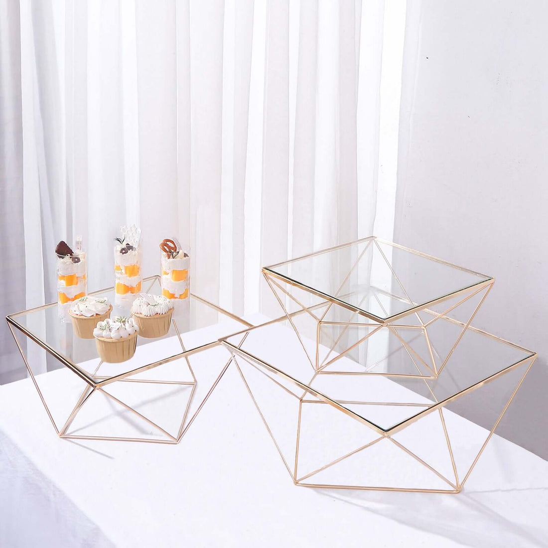 Stylish geometric glass-top tables with gold metal frames