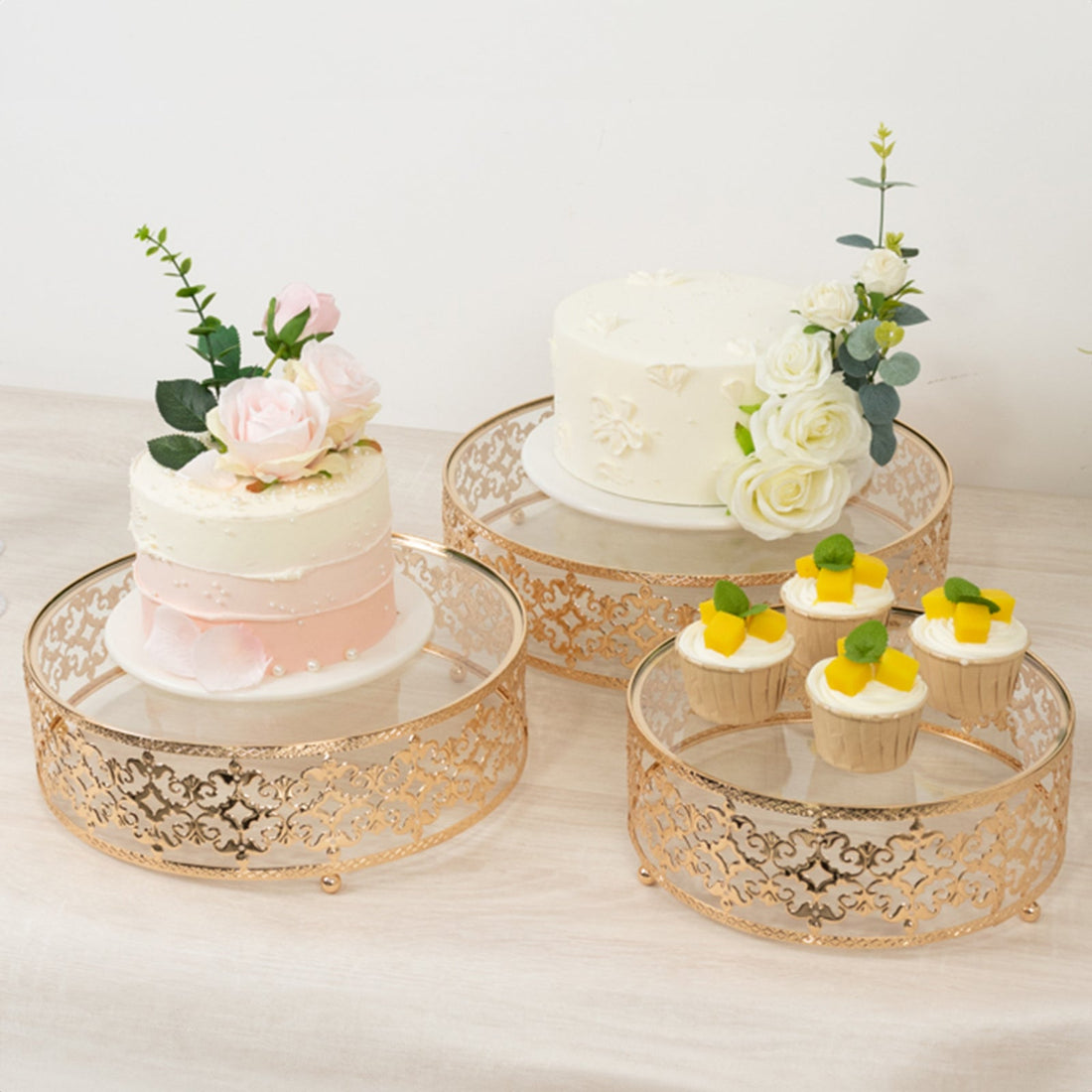 Elegant cake stands with floral decorations and desserts for celebrations.