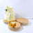 Elegant three-tier wedding cake adorned with white flowers on decorative cake stands.