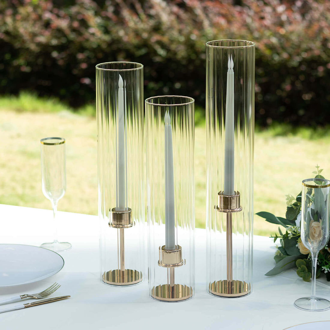 Elegant glass candle holders with gold accents, perfect for dining table decor.