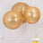 Three hanging gold sequin lanterns in a bright setting.