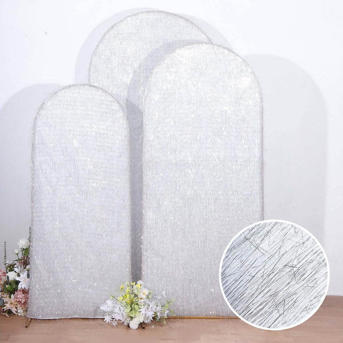 Silver sequin arch backdrop with floral accents