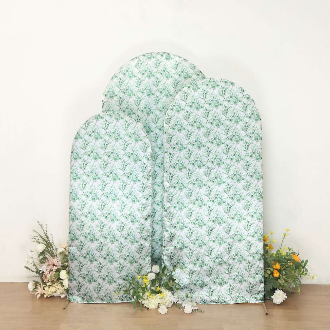Floral backdrop display with three arches and decorative flowers at the base.