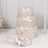 Decorative floral gift boxes with bows stacked on a table.