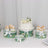 Decorative cake and dessert boxes with floral designs on a white backdrop.