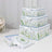 Decorative floral storage boxes stacked with ribbon accents.
