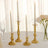 Elegant gold candlesticks with white candles on a table setting.