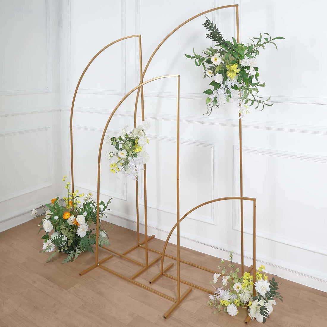 Gold arch backdrop with floral arrangements for events and photography.
