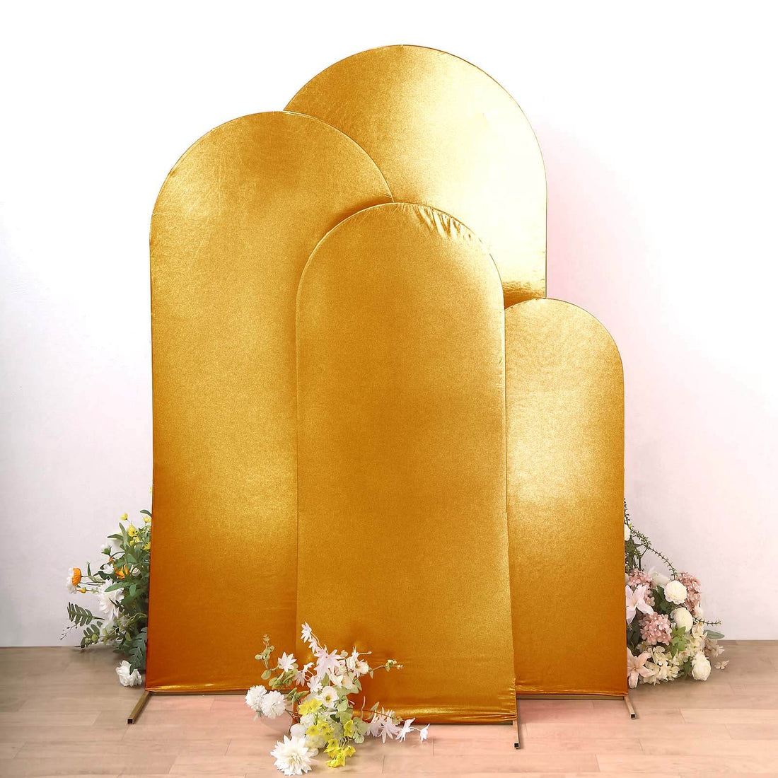 Golden arch backdrops with floral accents for events and photography