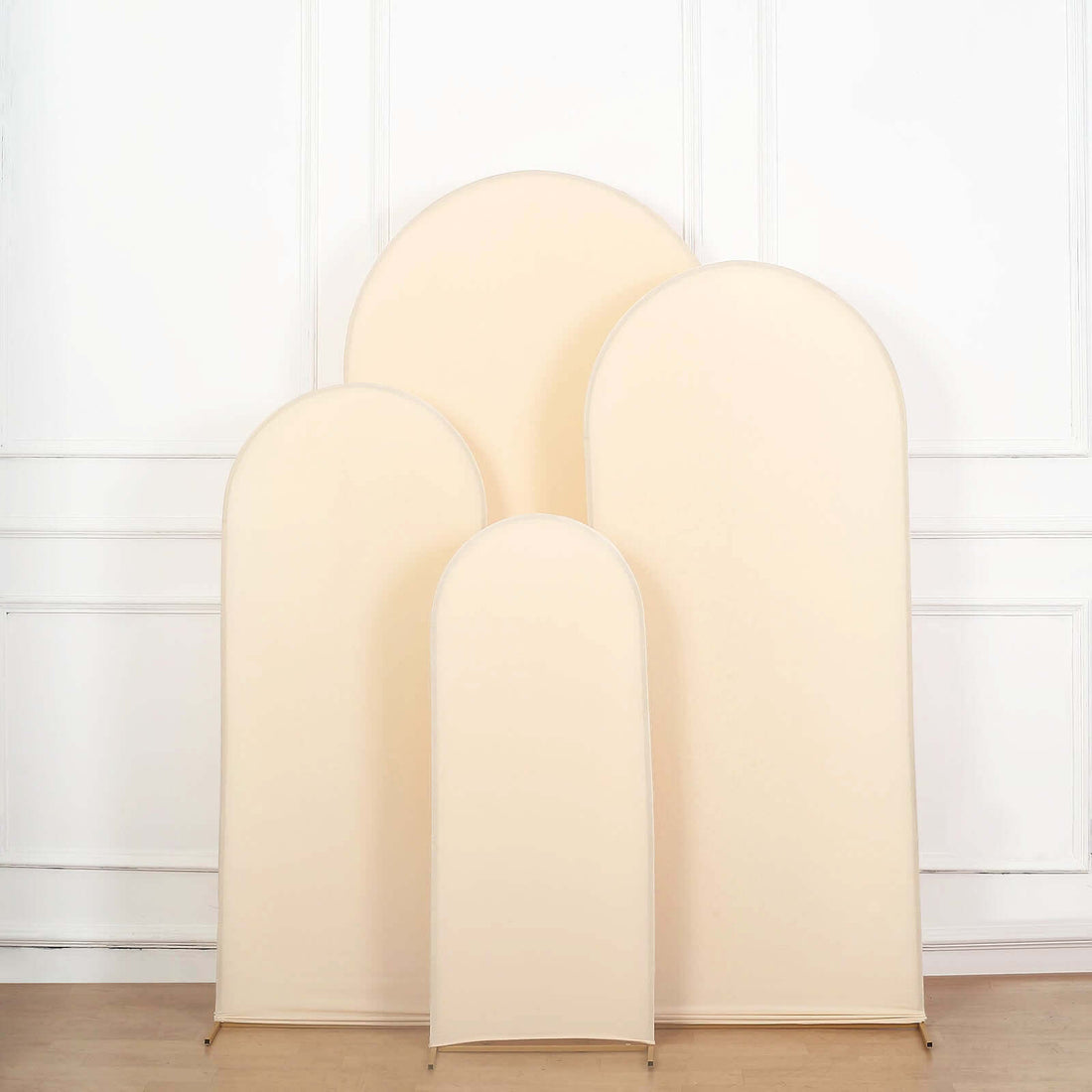 Four beige arch-shaped display boards in varying sizes.