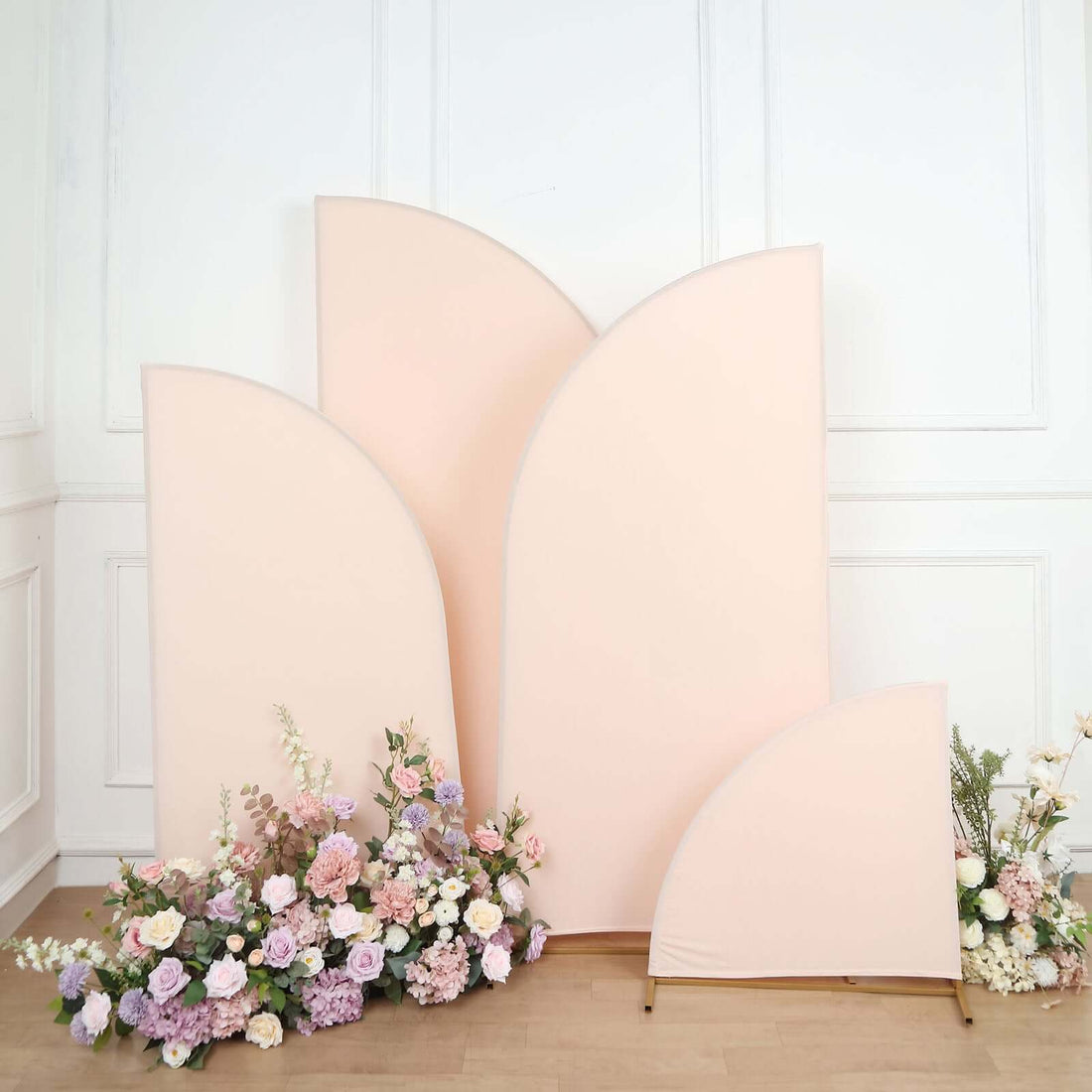 Peach backdrop panels with floral arrangements in a studio setting.