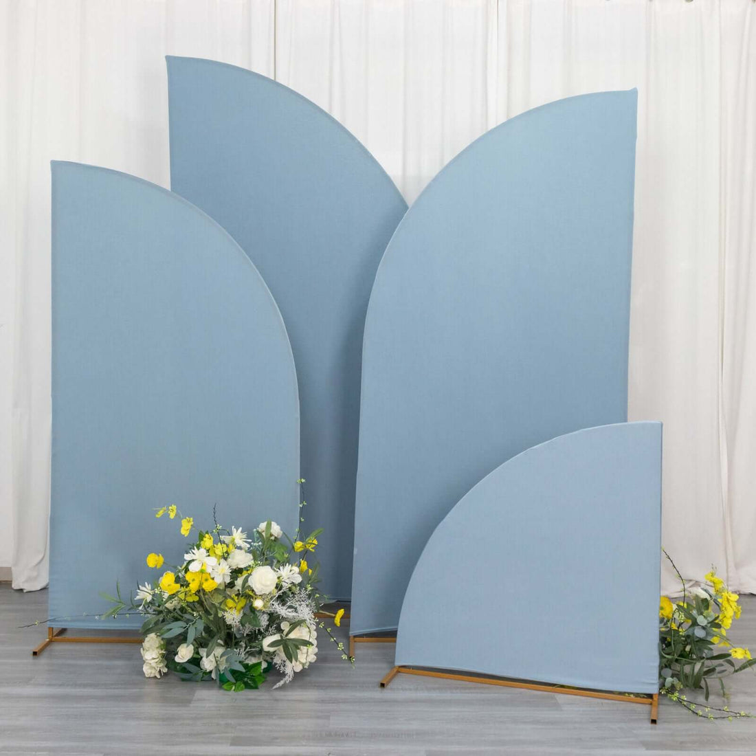 Blue fabric backdrops with floral arrangement, studio shot.