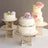 Elegant wedding cakes on decorative stands with floral accents.