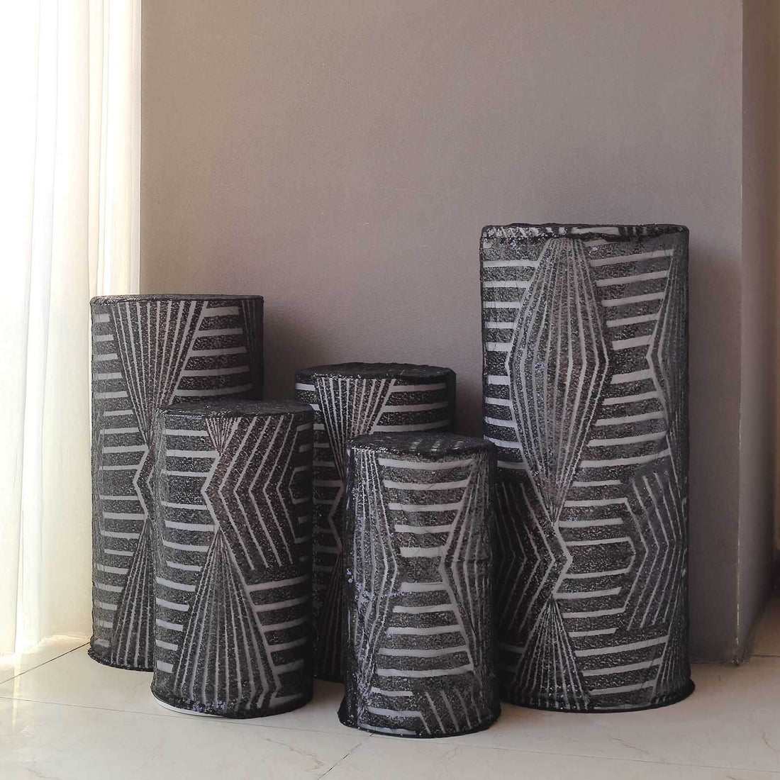 Decorative black and white patterned vases in various sizes.