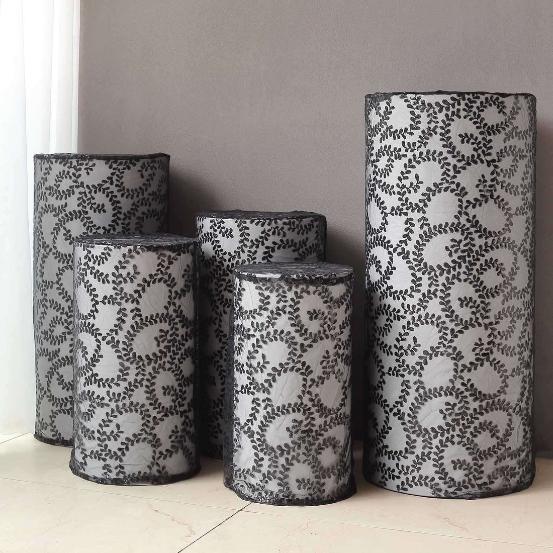 Decorative black and gray patterned vases in various sizes on a neutral background.