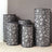 Decorative black and gray patterned vases in various sizes on a neutral background.