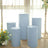 Blue display pedestals arranged in a bright, airy space with flowers.