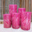 Pink decorative poufs with sequined wave patterns in various heights.