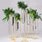 Gold plant stand with test tube vases and greenery arrangement.