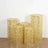 Set of five decorative yellow lace candle holders on a plain background.