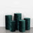 Green velvet pedestals in varying heights on a plain backdrop.