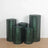 Green decorative cylindrical containers stacked on a wooden floor.