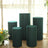 Set of five modern teal display pedestals in a bright indoor setting.