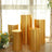 Set of five golden pedestal display stands in various heights.