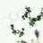 Decorative floral hoops with greenery and flowers on a white wall