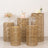 Rattan side tables in various heights with floral arrangements and cake display.