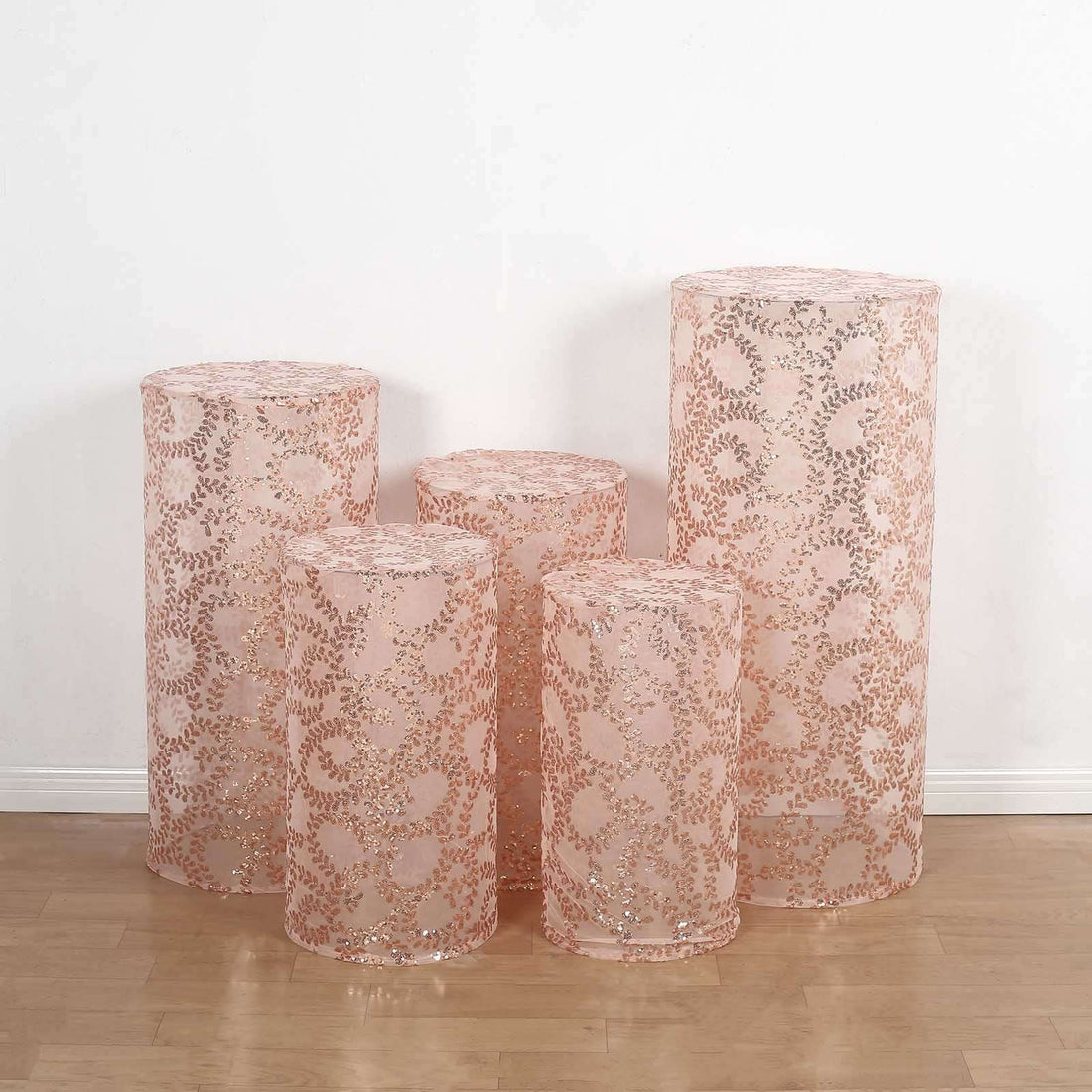 Set of five decorative rose gold lace cylinders