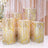 Glittery gold and pink sequin display pedestals in various heights.