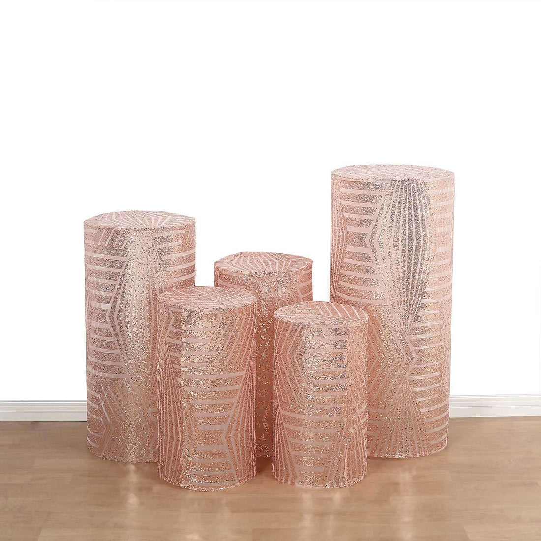 Set of five decorative cylindrical storage containers in pink with metallic accents