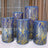 Decorative blue and gold cylindrical vases in various heights.