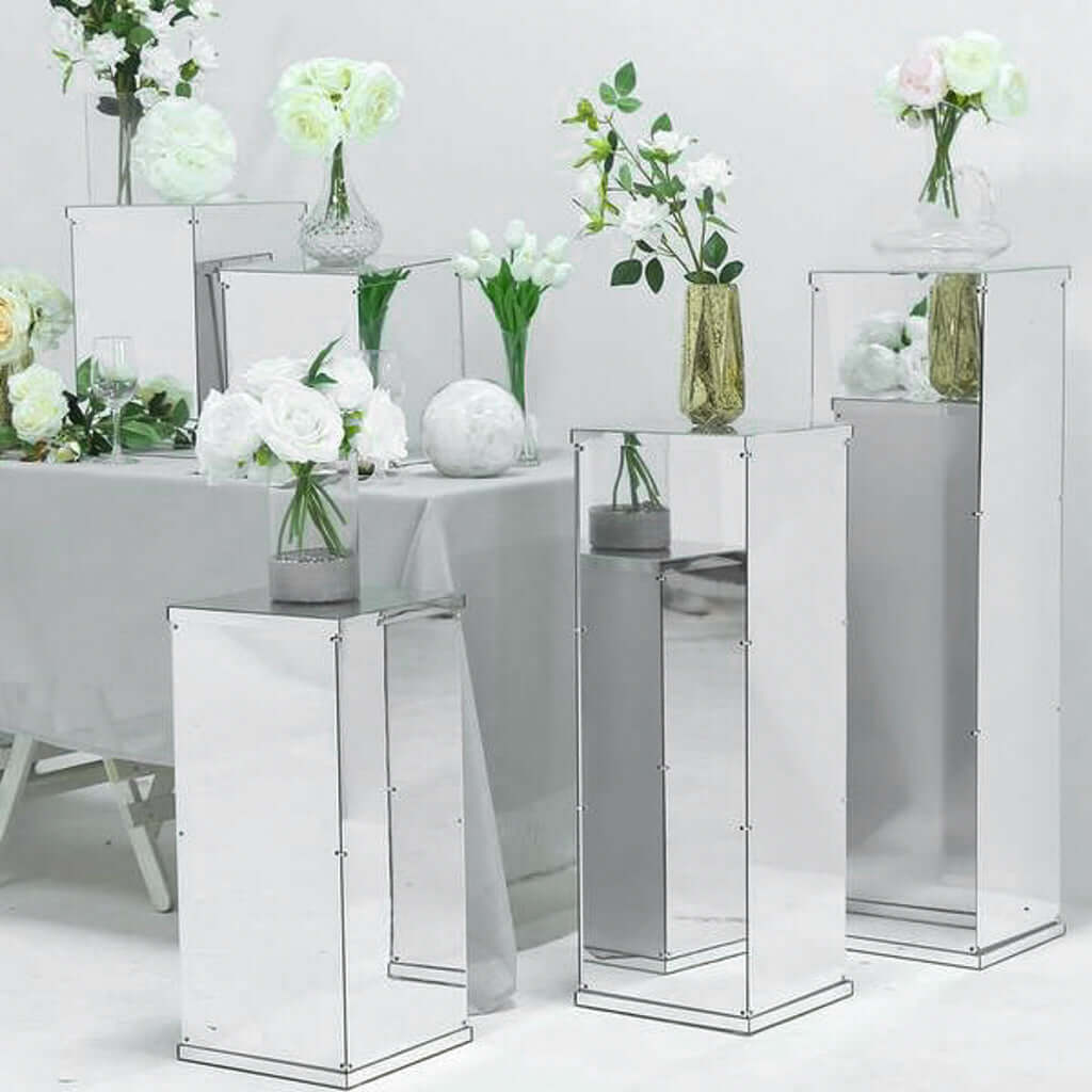Mirrored display pedestals with floral arrangements on a white background #whtbkgd