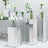 Mirrored display pedestals with floral arrangements on a white background #whtbkgd