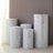 Decorative silver-patterned vases in various sizes against a neutral wall backdrop.