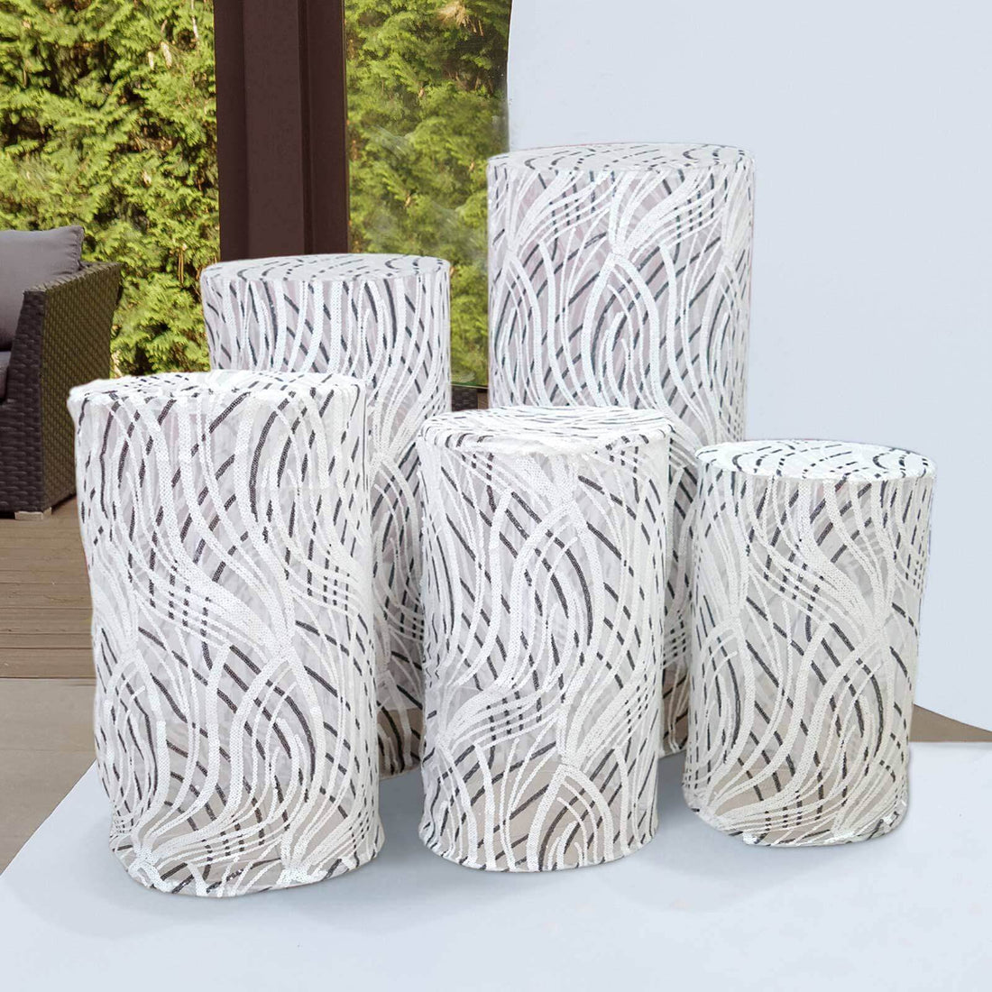Decorative white and gray textured cylindrical vases in varying heights.