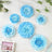 Blue flower wall decor set in various sizes on a light background.